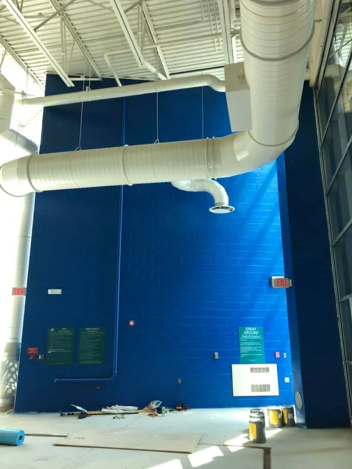 Commercial high-bay interior with freshly painted blue walls