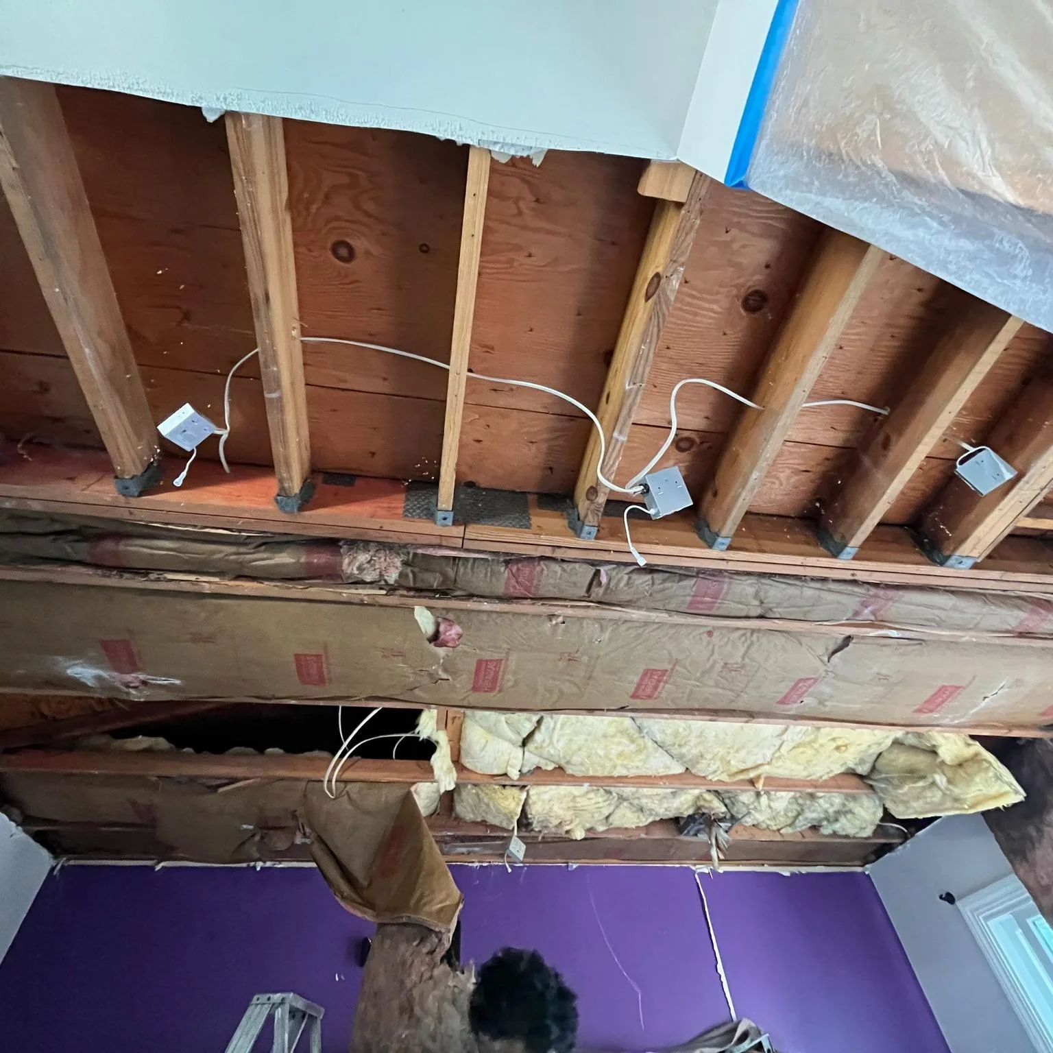 Exposed ceiling joists during a drywall repair and finishing project