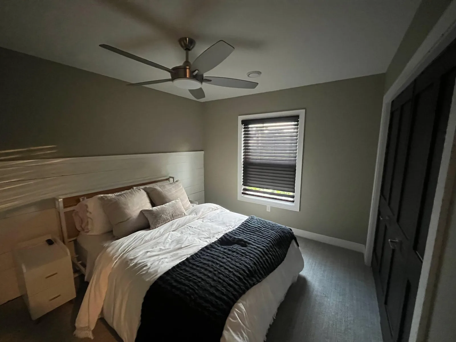 Bedroom with freshly painted soft gray walls, white trim, and ceiling