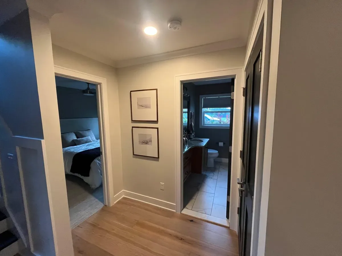 Neutral repainted hallway with crisp white trim and doorways