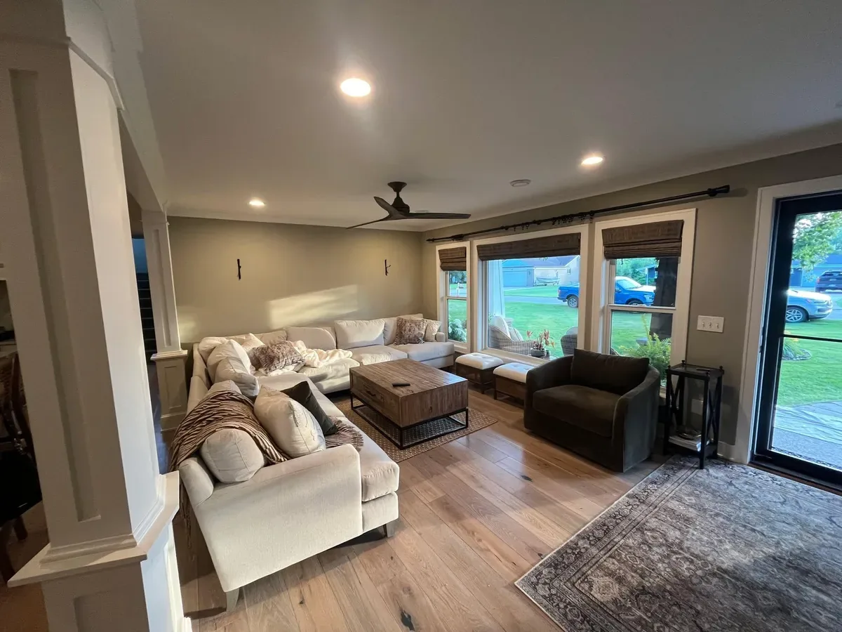 Living room with freshly painted walls, white trim, and hardwood floors